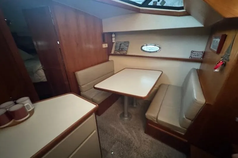 Slide: The Image of Interior of 1992 Carver 38 Aft Cabin Motor Yacht with dining area and seating. - 15