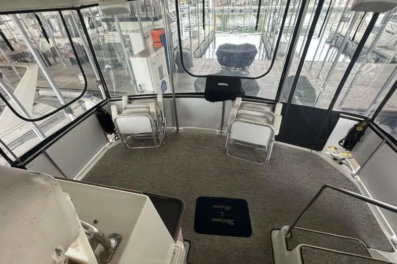 Slide: The Image of 1992 Carver 38 Aft Cabin Motor Yacht interior with seating and marina view. - 8