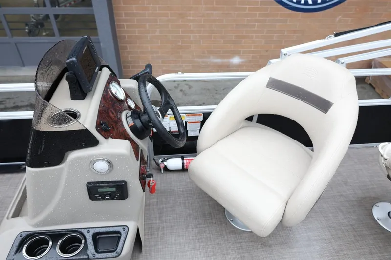 Slide: The Image of 2022 Sun Tracker Bass Buggy 18 DLX boat interior with steering console and captain's chair. - 13