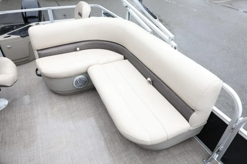 Slide: The Image of 2022 Sun Tracker Bass Buggy 18 DLX pontoon boat with beige seating and speaker. - 14
