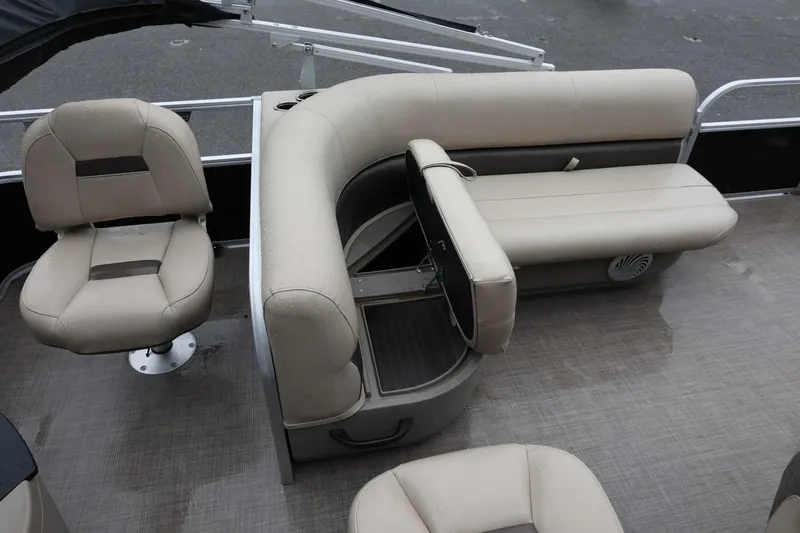 Slide: The Image of 2022 Sun Tracker Bass Buggy 18 DLX interior seating with beige upholstery and storage. - 16