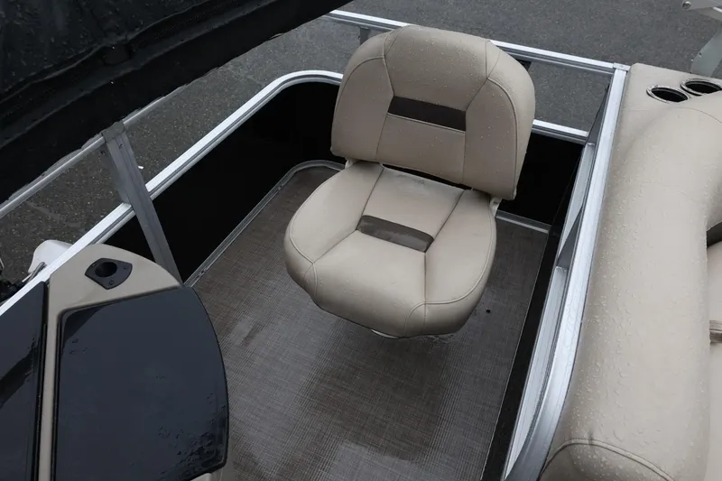 Slide: The Image of 2022 Sun Tracker Bass Buggy 18 DLX boat interior with beige seating and cup holders. - 17