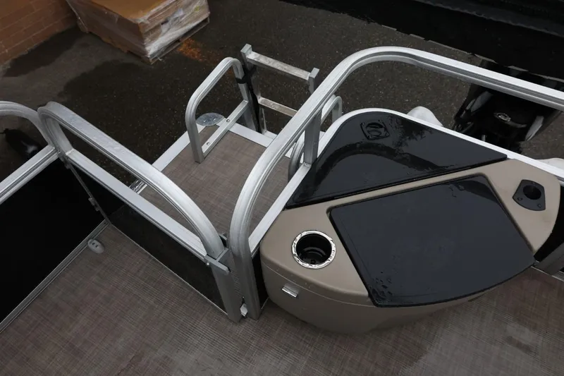 Slide: The Image of 2022 Sun Tracker Bass Buggy 18 DLX pontoon boat deck with railing and storage. - 18