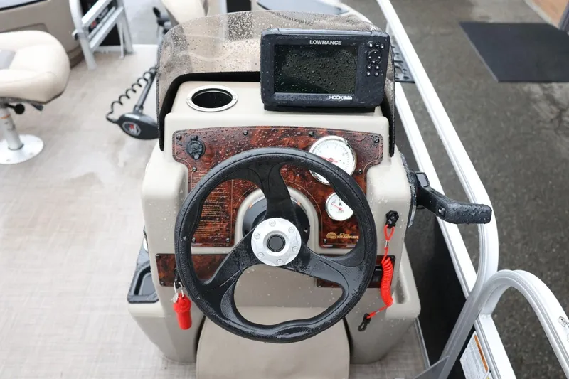 Slide: The Image of 2022 Sun Tracker Bass Buggy 18 DLX steering console with gauges and Lowrance fishfinder. - 21