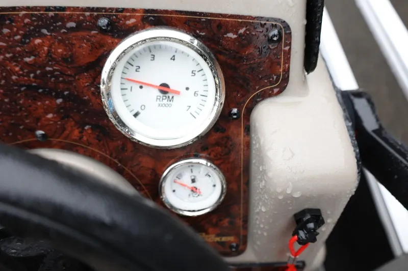 Slide: The Image of Close-up of 2022 Sun Tracker Bass Buggy 18 DLX dashboard with RPM gauge. - 22
