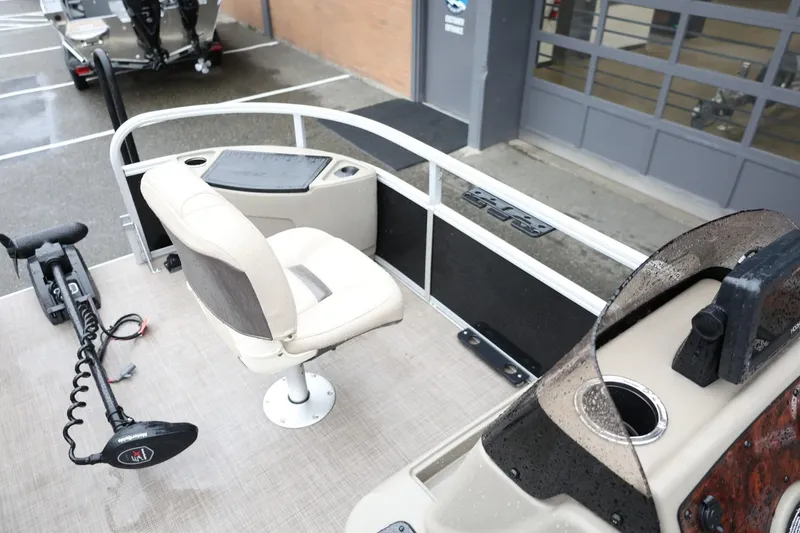 Slide: The Image of 2022 Sun Tracker Bass Buggy 18 DLX pontoon boat interior with seating and controls. - 24