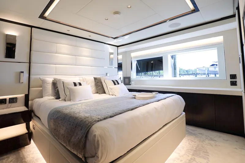 Slide: The Image of Luxurious bedroom interior on 2025 Majesty 120 yacht, featuring elegant design and large window. - 51