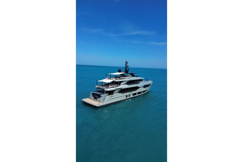 Slide: The Image of Luxurious 2025 Majesty 120 yacht cruising on clear blue ocean waters. - 96