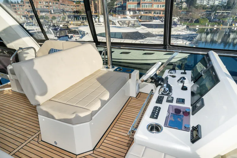 Slide: The Image of Luxurious 2018 Prestige 630 yacht helm with modern controls and comfortable seating. - 11
