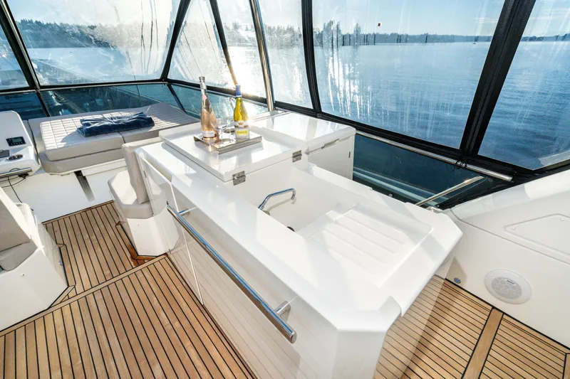 Slide: The Image of Luxurious 2018 Prestige 630 yacht interior with elegant seating and scenic ocean view. - 12