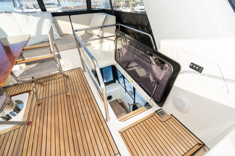 Slide: The Image of Luxurious 2018 Prestige 630 yacht interior with wooden flooring and comfortable seating. - 19