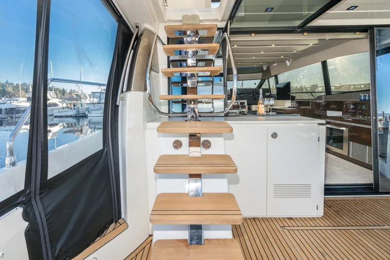Slide: The Image of Interior view of 2018 Prestige 630 yacht with wooden stairs and modern kitchen. - 20