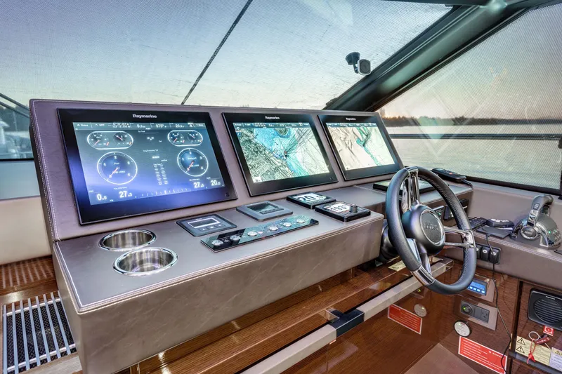 Slide: The Image of Cockpit of 2018 Prestige 630 yacht with advanced navigation displays and controls. - 32