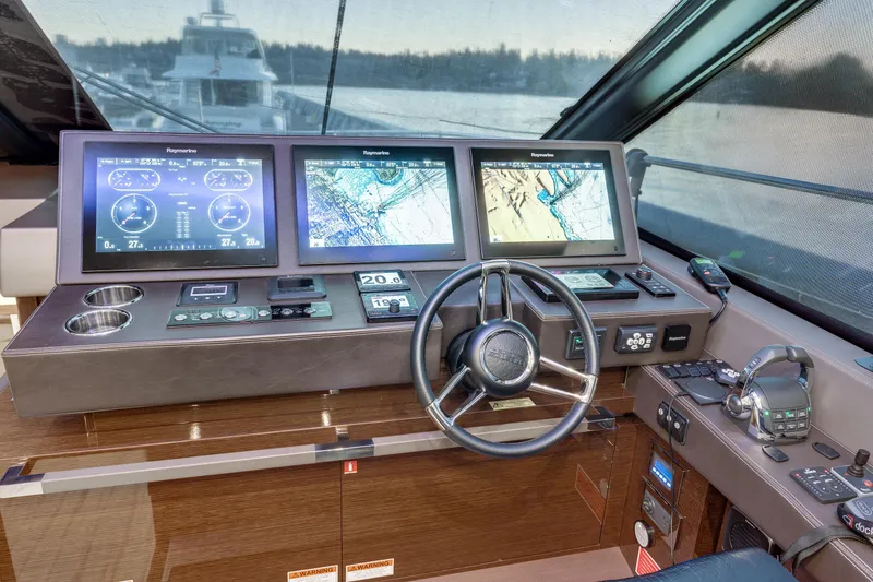 Slide: The Image of Cockpit of 2018 Prestige 630 yacht with advanced navigation displays and controls. - 33