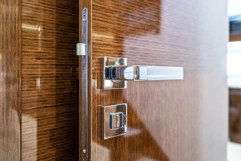 Slide: The Image of Sleek wooden door with modern chrome handle on 2018 Prestige 630 yacht. - 52