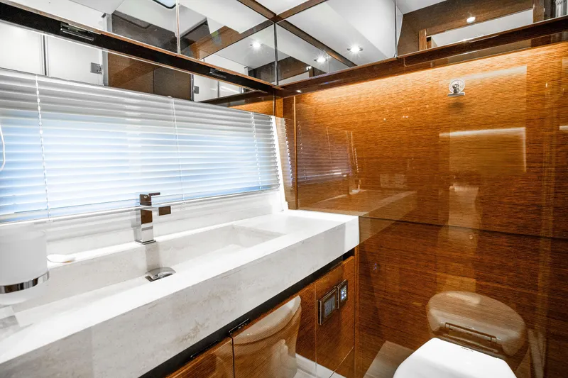 Slide: The Image of Luxurious bathroom interior of 2018 Prestige 630 yacht with modern fixtures and wooden accents. - 53