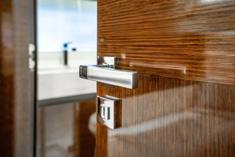 Slide: The Image of Close-up of a sleek wooden door handle on a 2018 Prestige 630 yacht. - 58