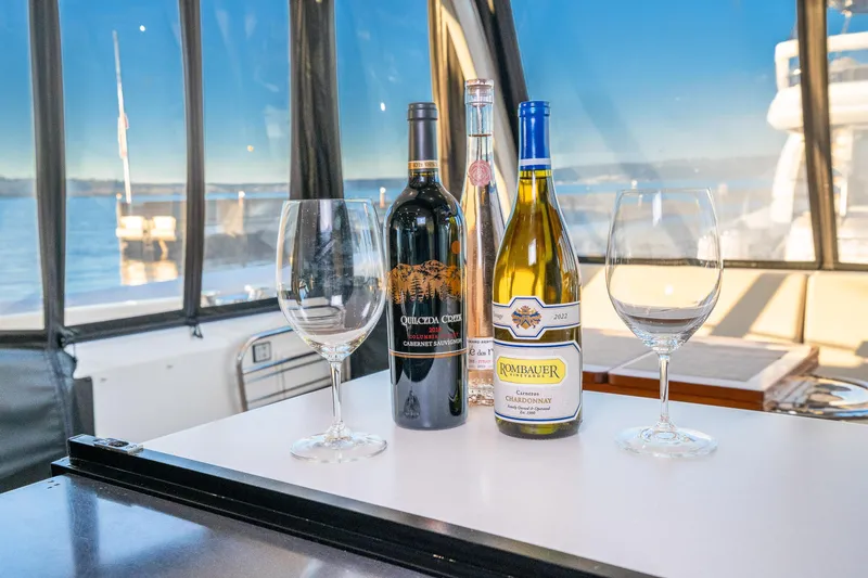 Slide: The Image of Wine bottles and glasses on a 2018 Prestige 630 yacht with scenic water view. - 59
