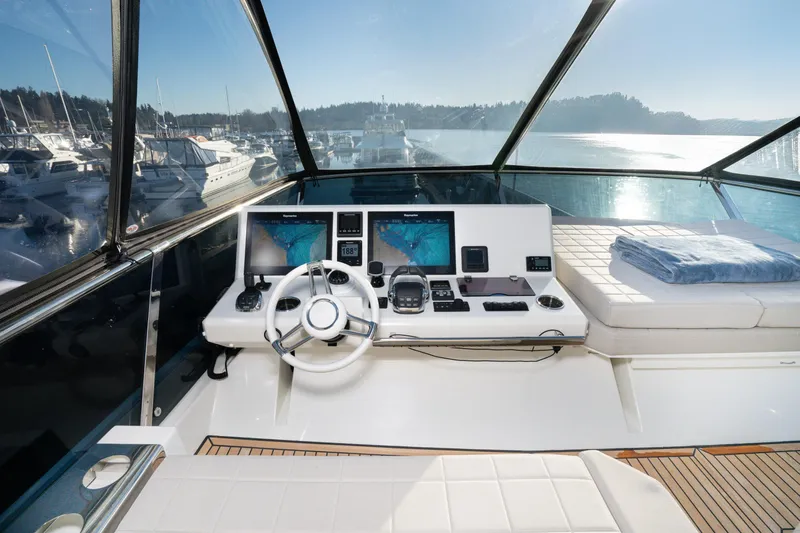 Slide: The Image of Cockpit of 2018 Prestige 630 yacht with navigation screens and steering wheel. - 6