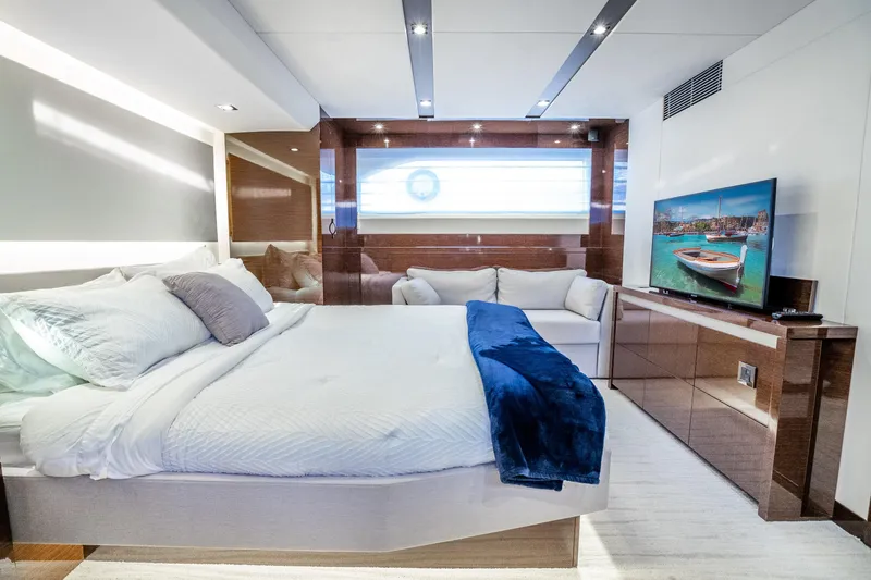 Slide: The Image of Luxurious 2018 Prestige 630 yacht bedroom with modern decor and large TV. - 63