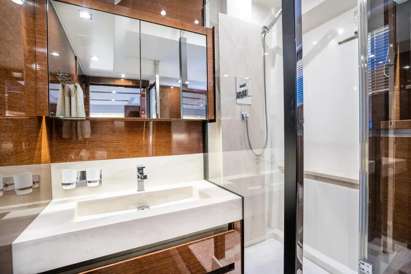 Slide: The Image of Luxurious bathroom interior on a 2018 Prestige 630 yacht, featuring modern fixtures and elegant wood finishes. - 70