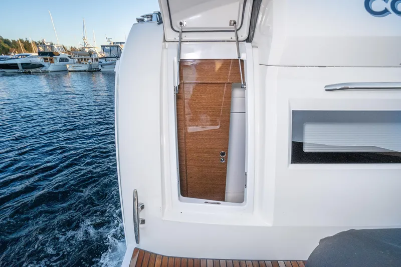 Slide: The Image of 2018 Prestige 630 yacht stern view with open hatch, docked in marina. - 74