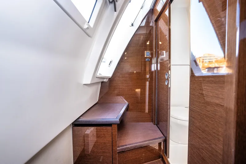 Slide: The Image of Interior of 2018 Prestige 630 yacht, featuring sleek wooden finishes and modern design elements. - 75