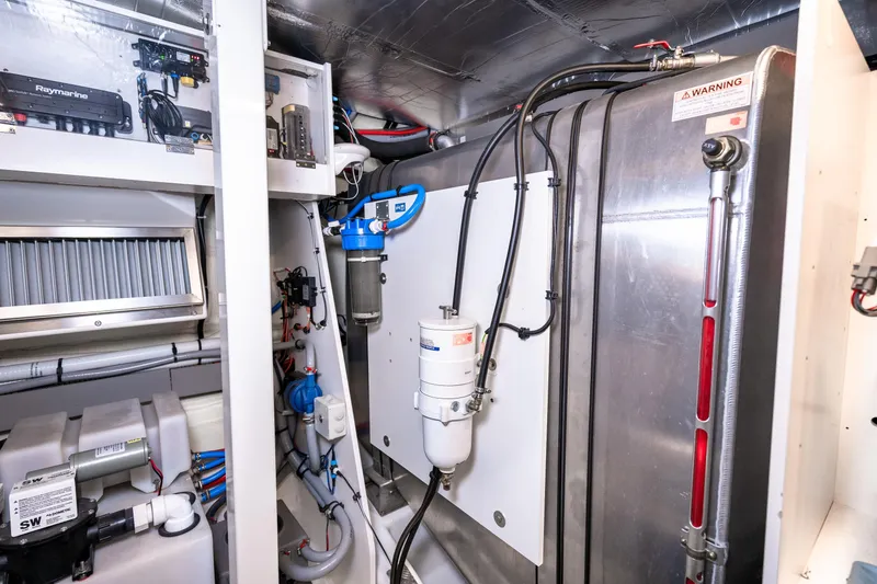 Slide: The Image of Engine room of a 2018 Prestige 630 yacht, showcasing equipment and wiring. - 86