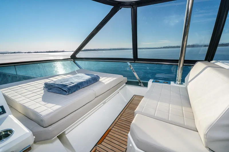 Slide: The Image of Luxurious 2018 Prestige 630 yacht interior with panoramic ocean view and plush seating. - 9