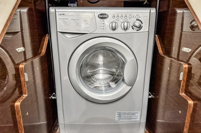 Slide: The Image of Front-loading washing machine in a Prestige 630 yacht, 2018 model, with wooden cabinetry. - 90