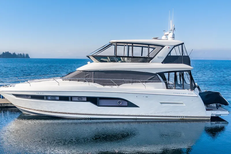 Slide: The Image of Luxury 2018 Prestige 630 yacht docked on serene blue waters. - 92