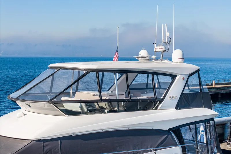 Slide: The Image of 2018 Prestige 630 yacht docked by the sea, featuring sleek design and modern amenities. - 94