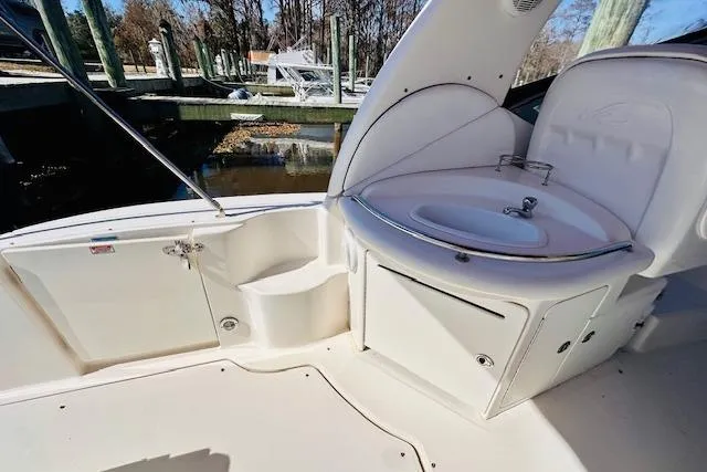 Slide: The Image of 2006 Sea Ray 340 Sundancer boat interior with sink and storage compartments. - 12
