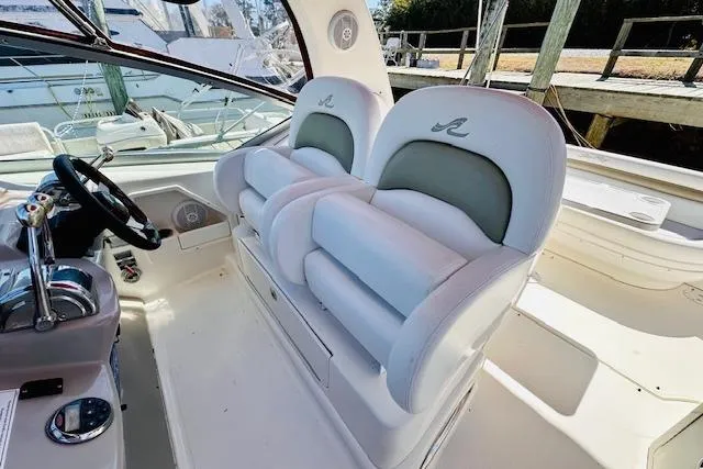 Slide: The Image of 2006 Sea Ray 340 Sundancer cockpit with dual helm seats and steering wheel. - 14
