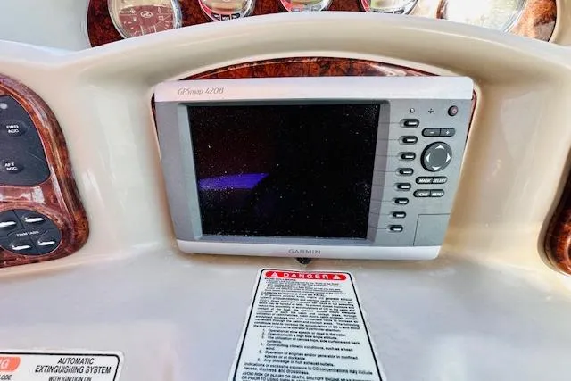 Slide: The Image of Garmin GPS on 2006 Sea Ray 340 Sundancer dashboard with warning label. - 17