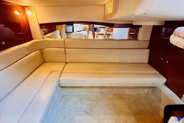 Slide: The Image of 2006 Sea Ray 340 Sundancer interior with beige seating and wood accents. - 18