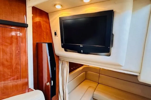 Slide: The Image of Interior of 2006 Sea Ray 340 Sundancer with TV and beige seating area. - 20