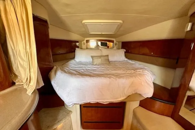Slide: The Image of Luxurious cabin interior of 2006 Sea Ray 340 Sundancer with cozy bed and wooden accents. - 25