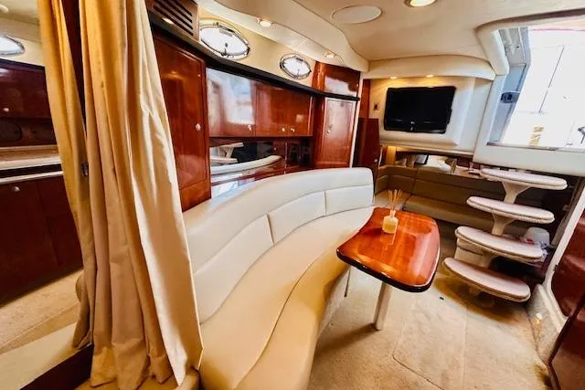 Slide: The Image of Luxurious 2006 Sea Ray 340 Sundancer interior with elegant seating and wooden cabinetry. - 27