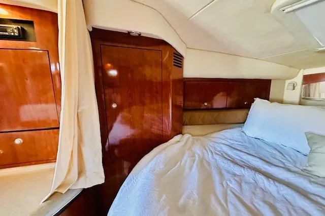 Slide: The Image of Luxurious cabin interior of 2006 Sea Ray 340 Sundancer with wood finish and cozy bedding. - 29