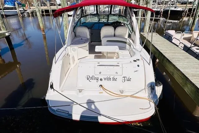 Slide: The Image of 2006 Sea Ray 340 Sundancer docked, featuring "Rolling with the Tide" on the stern. - 3