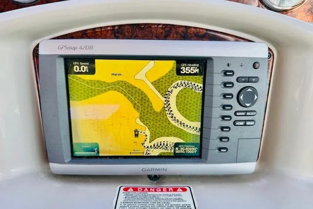 Slide: The Image of Garmin GPSmap 4208 on 2006 Sea Ray 340 Sundancer boat dashboard, displaying navigation map. - 38