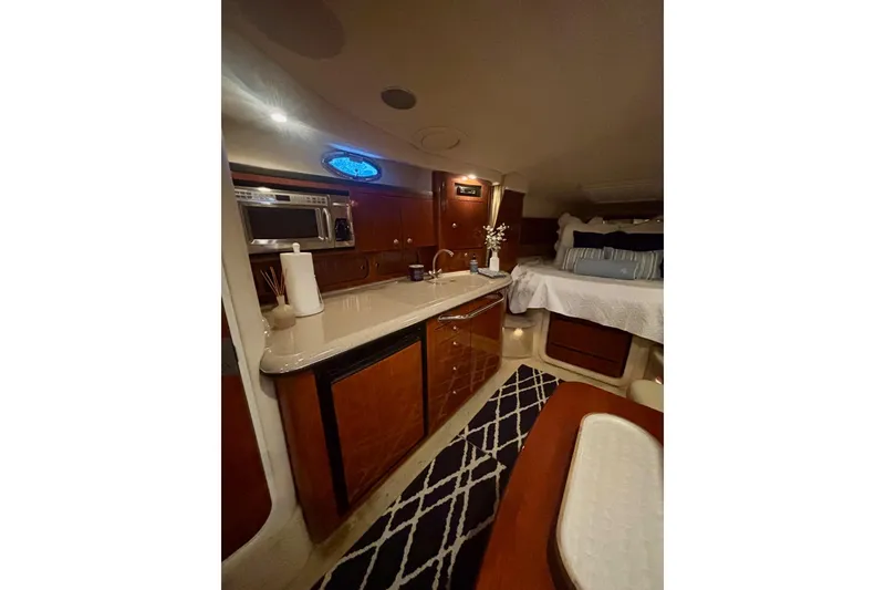 Slide: The Image of Luxurious interior of 2006 Sea Ray 340 Sundancer yacht with kitchenette and cozy sleeping area. - 39