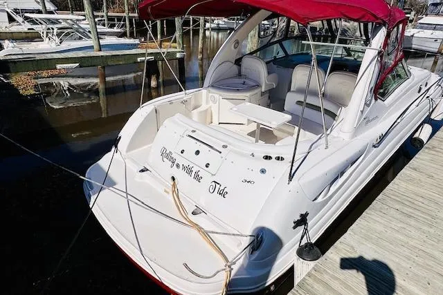 Slide: The Image of 2006 Sea Ray 340 Sundancer boat docked with red canopy and white seating. - 4