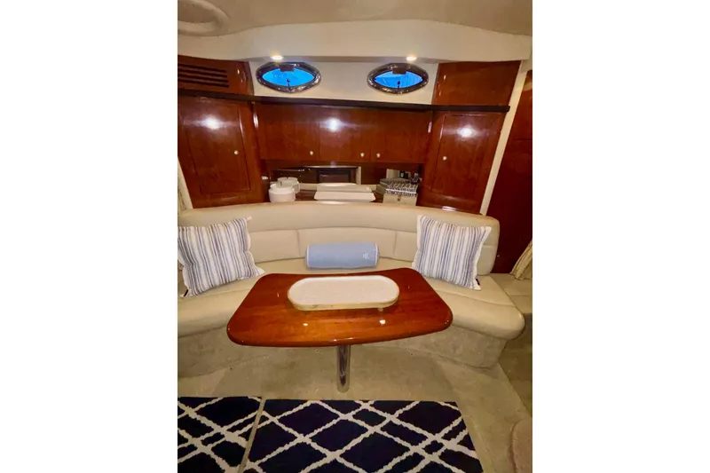 Slide: The Image of Interior of 2006 Sea Ray 340 Sundancer yacht with elegant seating and wooden finishes. - 42