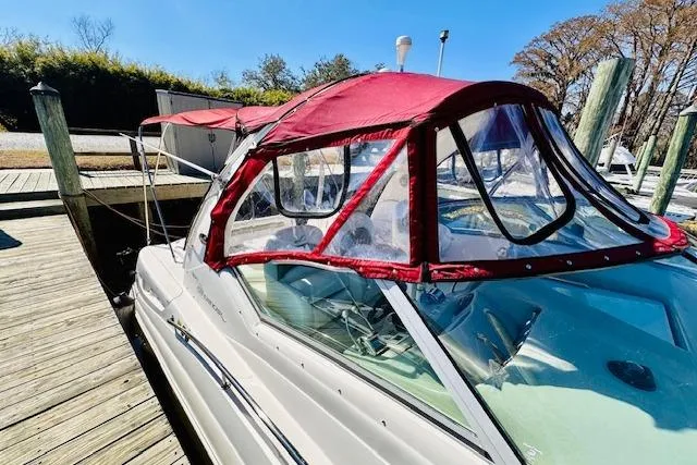 Slide: The Image of 2006 Sea Ray 340 Sundancer with red canopy docked at marina. - 5