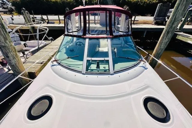 Slide: The Image of 2006 Sea Ray 340 Sundancer docked, featuring sleek design and spacious deck. - 7