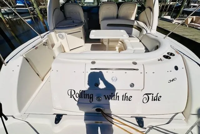 Slide: The Image of 2006 Sea Ray 340 Sundancer boat interior with seating and table, docked at marina. - 8