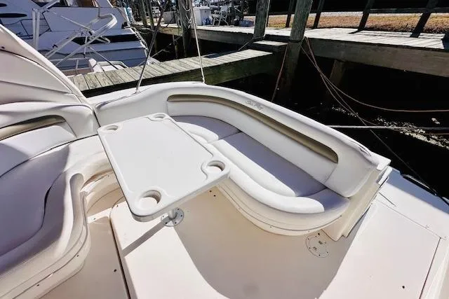 Slide: The Image of 2006 Sea Ray 340 Sundancer boat seating area with table, docked at marina. - 9