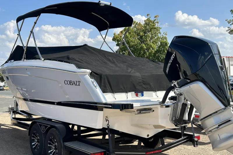 Slide: The Image of 2023 Cobalt R6 Outboard boat with Mercury engine on trailer, covered and ready for transport. - 2
